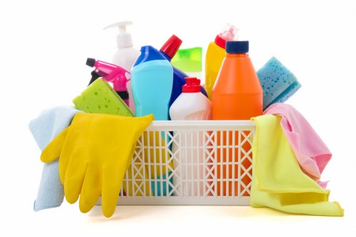 Domestic cleaner in Acton tidying a living room interior