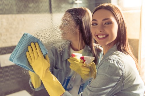 Carpet cleaning technician wearing PPE during an Acton property clean