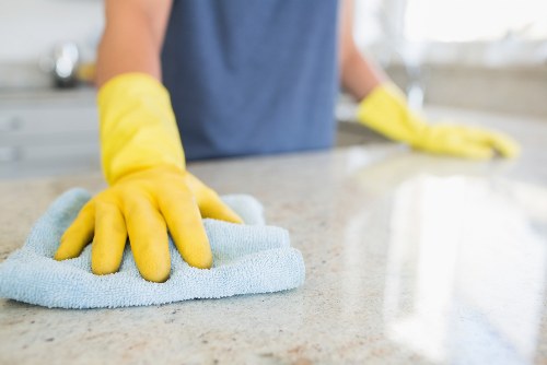Deep cleaning upholstery on a living room armchair in Acton